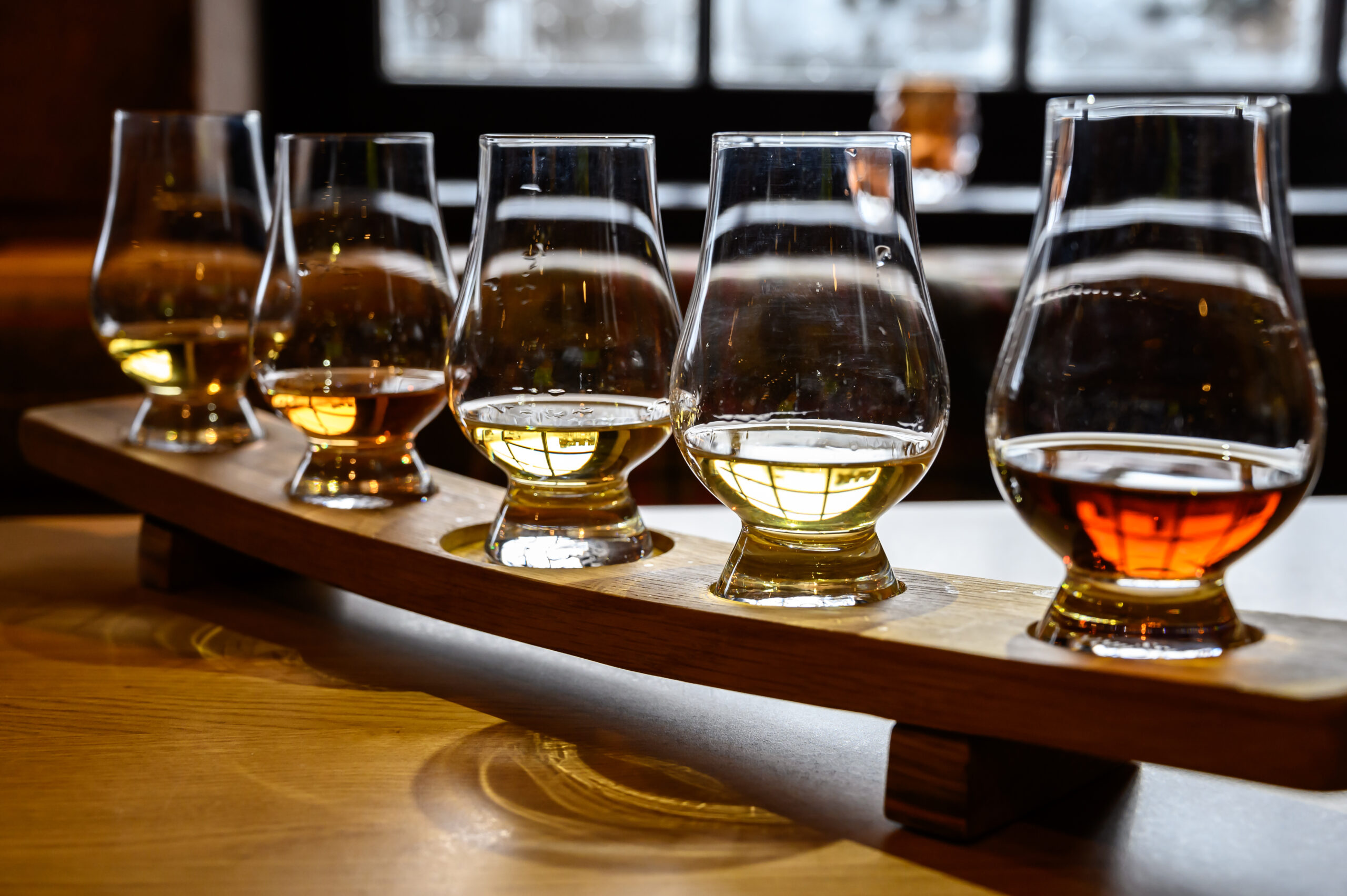 Set of Scottish whisky, tasting glasses with variety of single malts or blended whiskey spirits on distillery tour in Scotland, UK